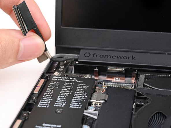 Lift the Display eDP Cable out of its slot in the Bottom Cover.