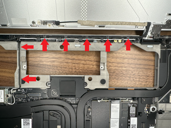 Route the Webcam Cable through the right hinge; placing it at the back of the guided channel.