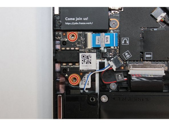 Using the T5 bit in the Framework Screwdriver screw in the two fasteners.