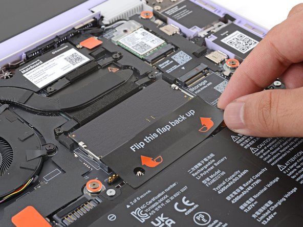 Flip the memory flap back over the memory module.