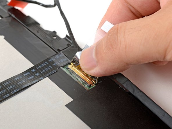 Make sure the locking bar doesn't fall back in place while you disconnect the display cable.