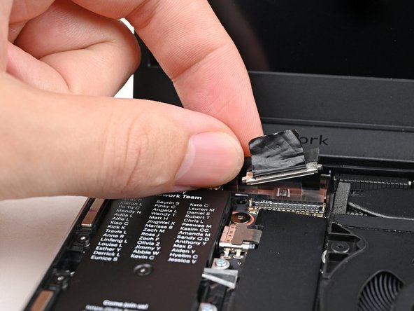 Lift the Display eDP Cable out of its slot in the Bottom Cover.