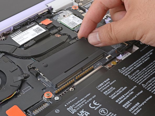 Flip the memory flap back over the memory module.