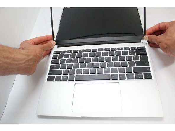 The Framework Bezel is attached by magnets so you will not require any tools to remove it. Just use your fingernail and pry the Bezel away from the display from one of the top corners of the Framework Laptop.