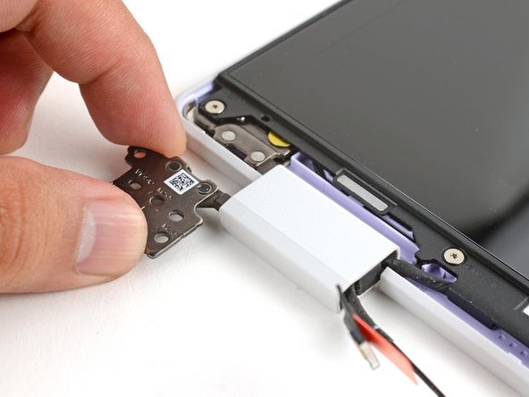 Twist the left hinge plate until it's flipped on top of the display.