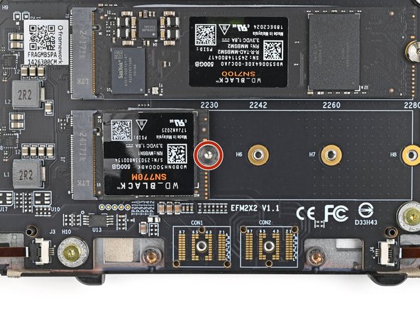 Use your Framework Screwdriver to install the 6.7 mm‑long screw securing the SSD.