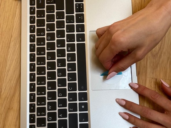 Now that the Touchpad is fastened to the input cover, turn the Input Cover over and gently remove the film guide.