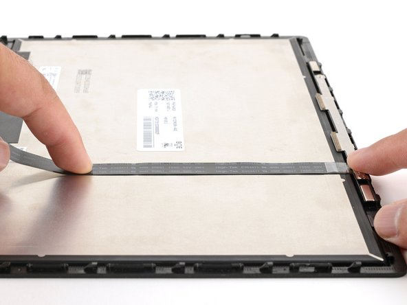 Use your fingers to press the cable onto the display.