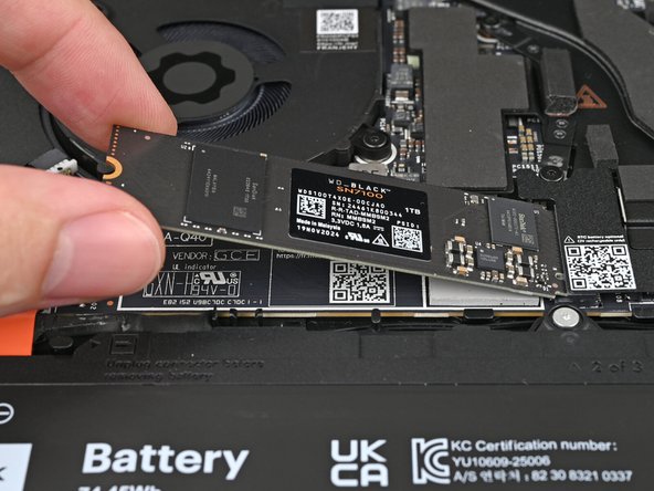 Insert the SSD into the socket at a shallow angle. The gold contacts should mostly be covered by the socket.
