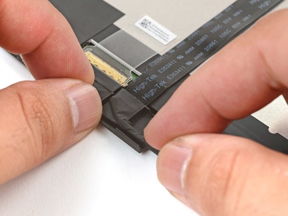 Guide the cable bend into its channel on the display.