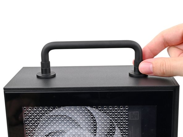 Place the Handle over the Top Panel screw holes.