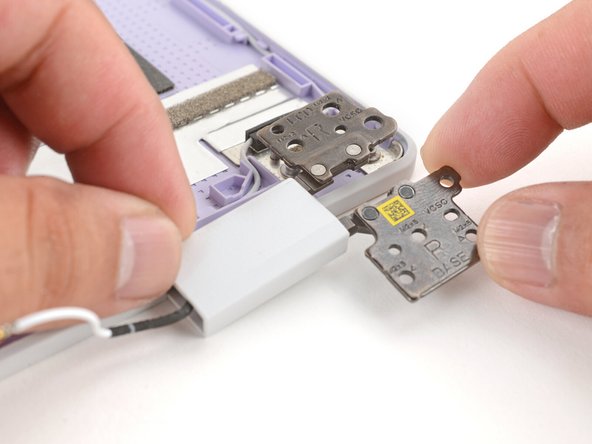 Lift and remove both hinges from the Top Cover.