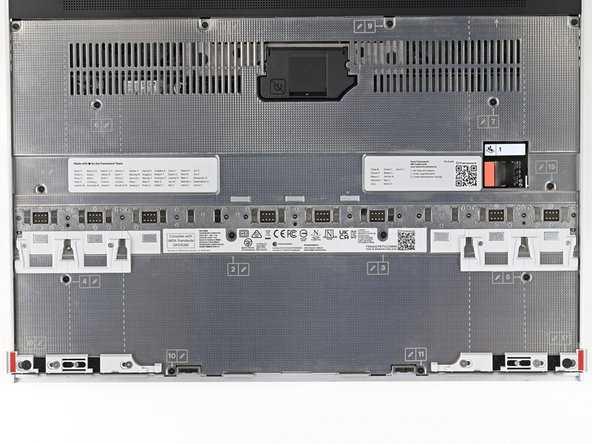 Use your Framework Screwdriver to loosen the 16 captive T5 Torx screws securing the Mid Plate.
