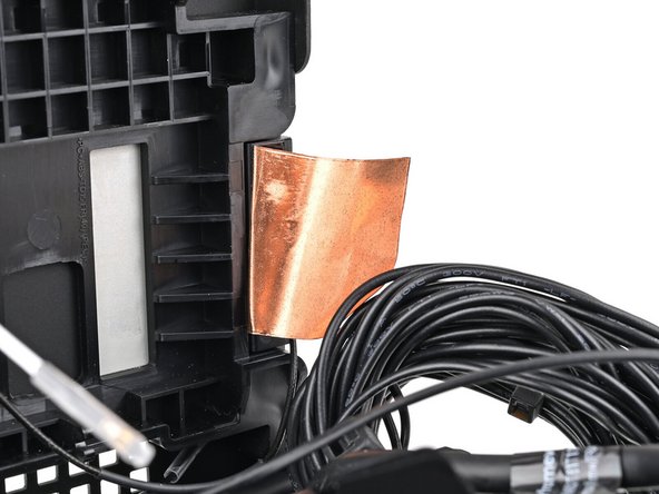 Remove the liner from the back of your replacement left antenna.