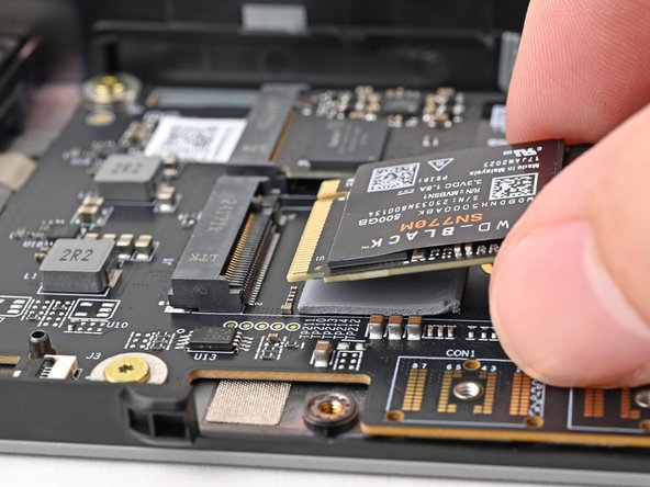 Hold the SSD by its edges. Don't touch the gold contacts with your fingers. If you do, wipe the contacts with a clean, lint-free cloth to remove any finger oils.