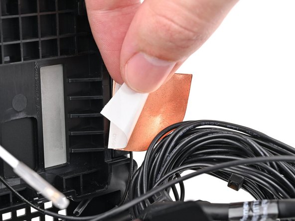 Remove the liner from the back of your replacement left antenna.