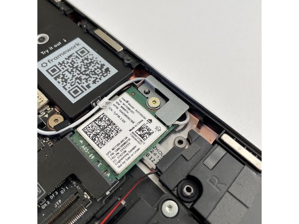 The antenna cables should not touch the Speaker located below.  Use the spudger end of the Framework Screwdriver to carefully push the white cable away from the Speaker if it is touching it.