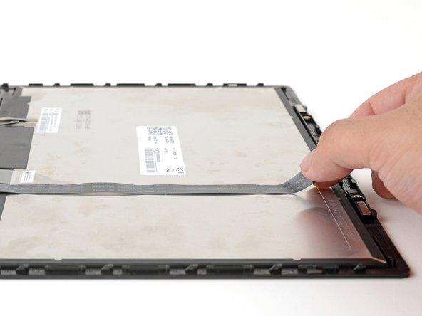 The webcam cable is lightly adhered to the display.