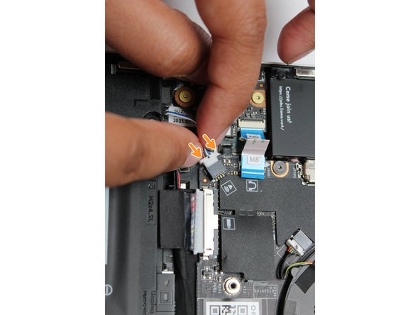 Using two fingers, slide the Speaker cable into the Mainboard using a straight motion and a slight amount of force.