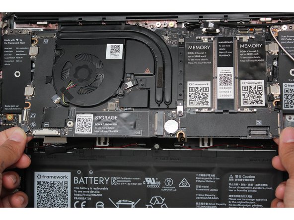 Using the T5 bit in the Framework Screwdriver, unscrew the five fasteners holding down the Mainboard.