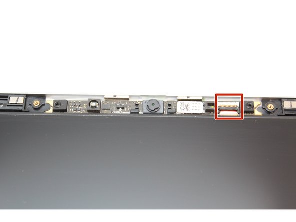 Using the T5 Bit in the Framework Screwdriver, unscrew the two fasteners connecting the Webcam Module to the Top Cover.