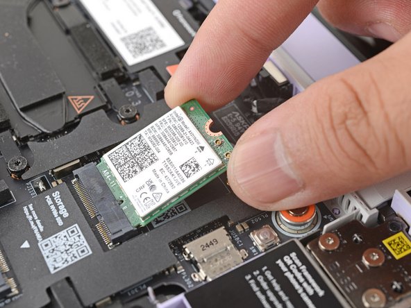 Align the Wi-Fi card's gold contacts and notch with the socket on the Mainboard.