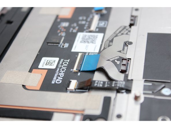 Flip the black latch down to secure the cable.