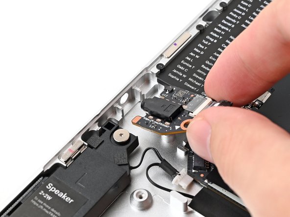 Angle the left edge of the Audio Board downward and slide the headphone jack through its hole in the Bottom Cover.