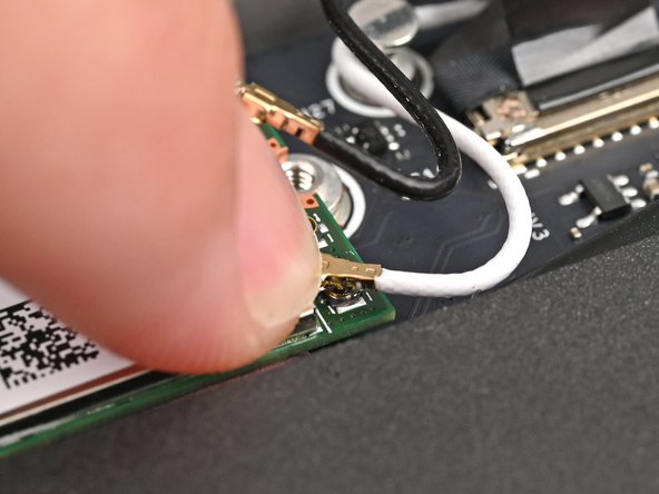 Hold the Wi-Fi module down with your finger.