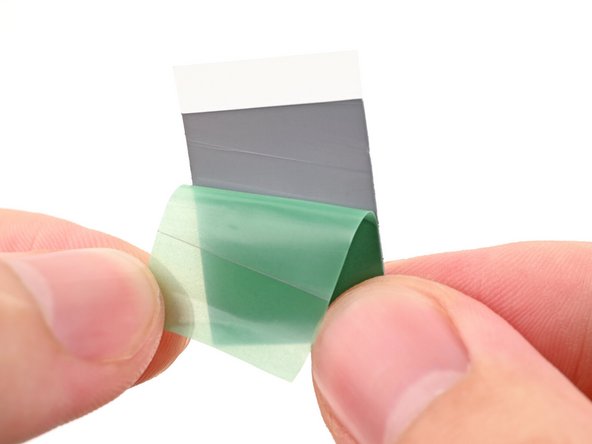 Remove the green liner from the replacement thermal pad to expose one side of it.