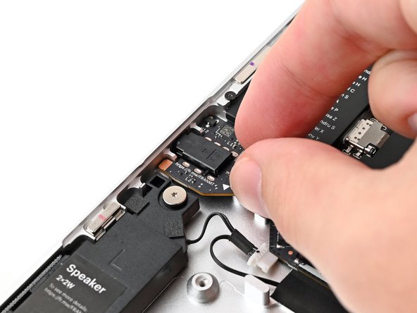 Align the screw hole in the Audio Board with its post and press it flat to the Bottom Cover.