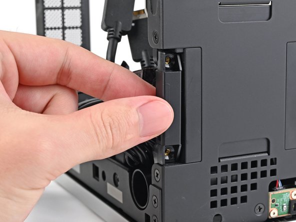 Lift the left antenna out of the chassis and remove it.