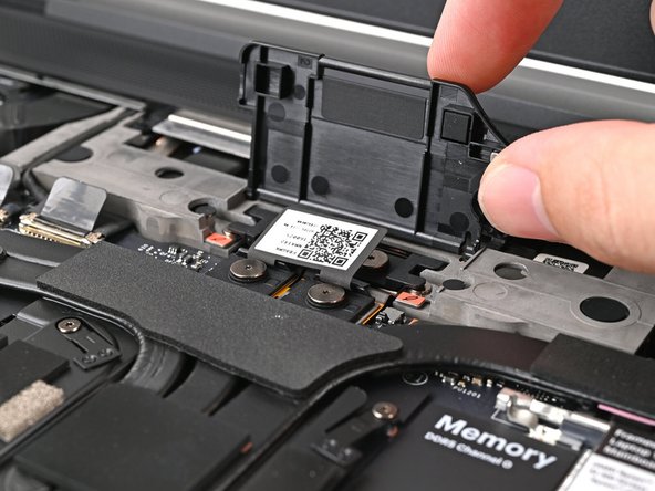 Lift the interposer door by its black pull tab and let it rest upright.