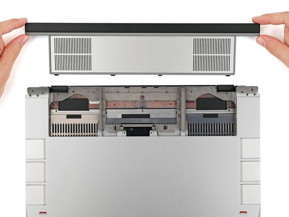 While keeping the shell level with the laptop, slide it into its slot.