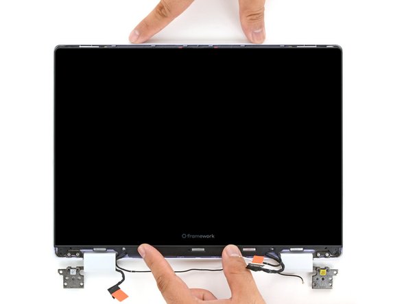 Use your fingers to slide the display upwards to latch the tabs on the top edge of the display.