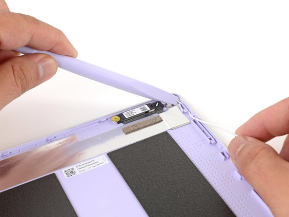 Use your fingers and your Framework Screwdriver to carefully guide each antenna cable back into its channel.