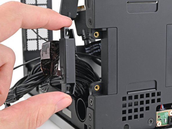 Lift the left antenna out of the chassis and remove it.