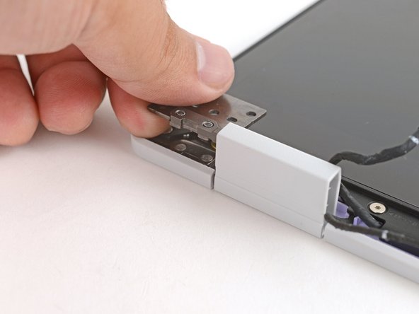 Use your fingers to twist both hinge plates so they're flipped over the display.