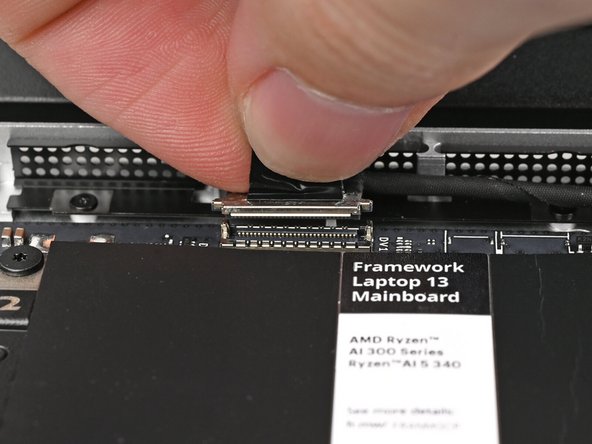 Press the Webcam Cable connector straight down into its socket to connect it.
