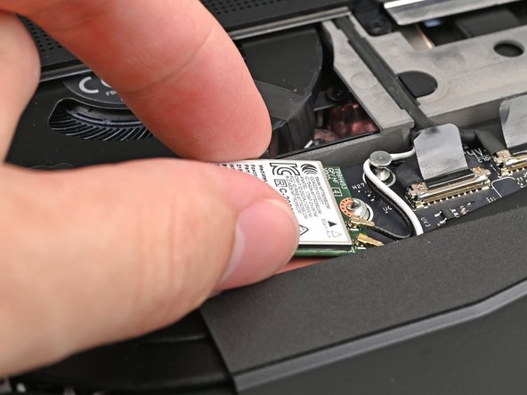 Rotate the Wi-Fi Module back into place, making sure the antenna cables wrap around their silver peg on the Mainboard and tuck underneath the heat sink.