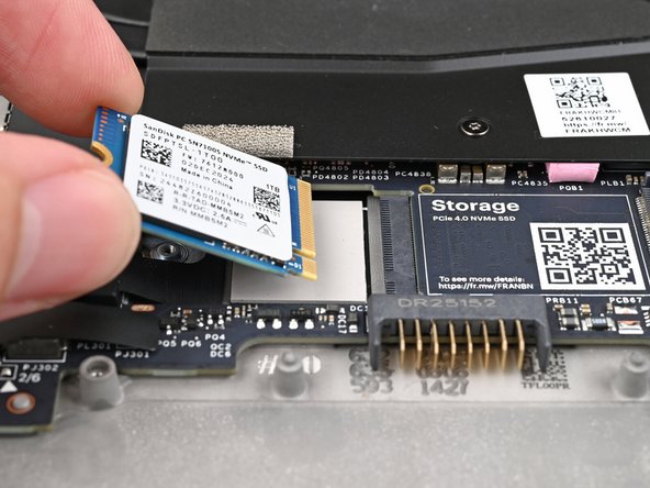 Hold the SSD by its edges. Don't touch the gold contacts with your fingers. If you do, wipe the contacts with a clean, lint-free cloth to remove any finger oils.