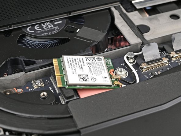 Rotate the Wi-Fi Module back into place, making sure the antenna cables wrap around their silver peg on the Mainboard and tuck underneath the heat sink.