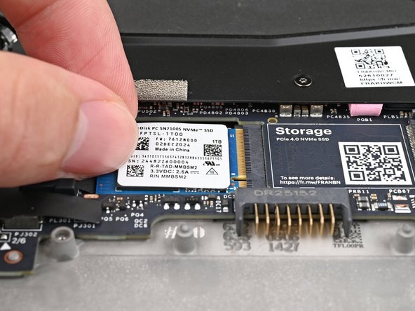 Insert the SSD partially into the socket at a shallow angle. You should still be able to see most of the gold contacts.