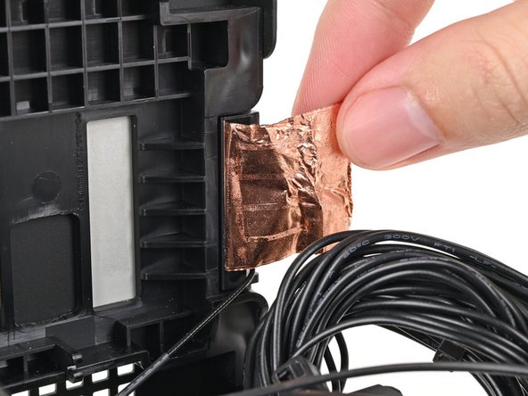 Use your fingers to peel the left antenna's copper film off the chassis.