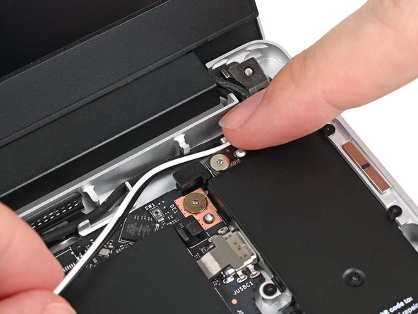 Rotate the cables around the raised corner at the top right of the Mainboard so they point towards the Wi-Fi module.