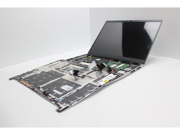 Once the Touchpad Cable is secured to the Mainboard, flip the Input Cover over the Bottom Cover so that the keyboard is facing up and attach it to the Bottom Cover by aligning the top and bottom edges of both covers.