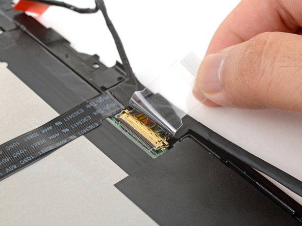 Use your fingers to peel up the clear tab covering the display cable connector.