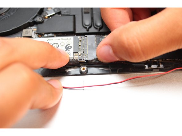 Peel the black tape back and place the wires under it. Cover the wires with same tape.