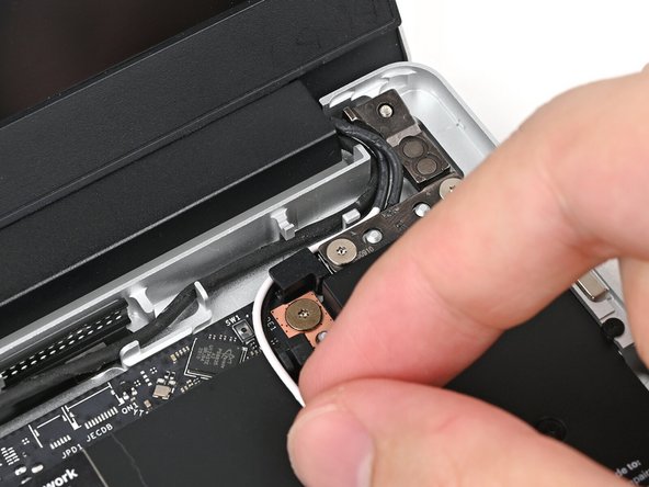 Refer to this photo for how the cables should look when properly routed.