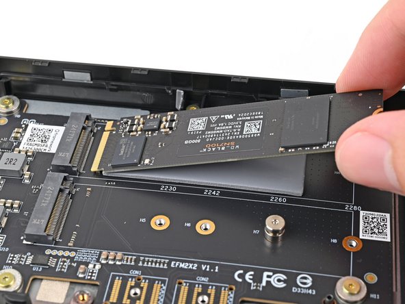 Hold the SSD by its edges. Don't touch the gold contacts with your fingers. If you do, wipe the contacts with a clean, lint-free cloth to remove any finger oils.
